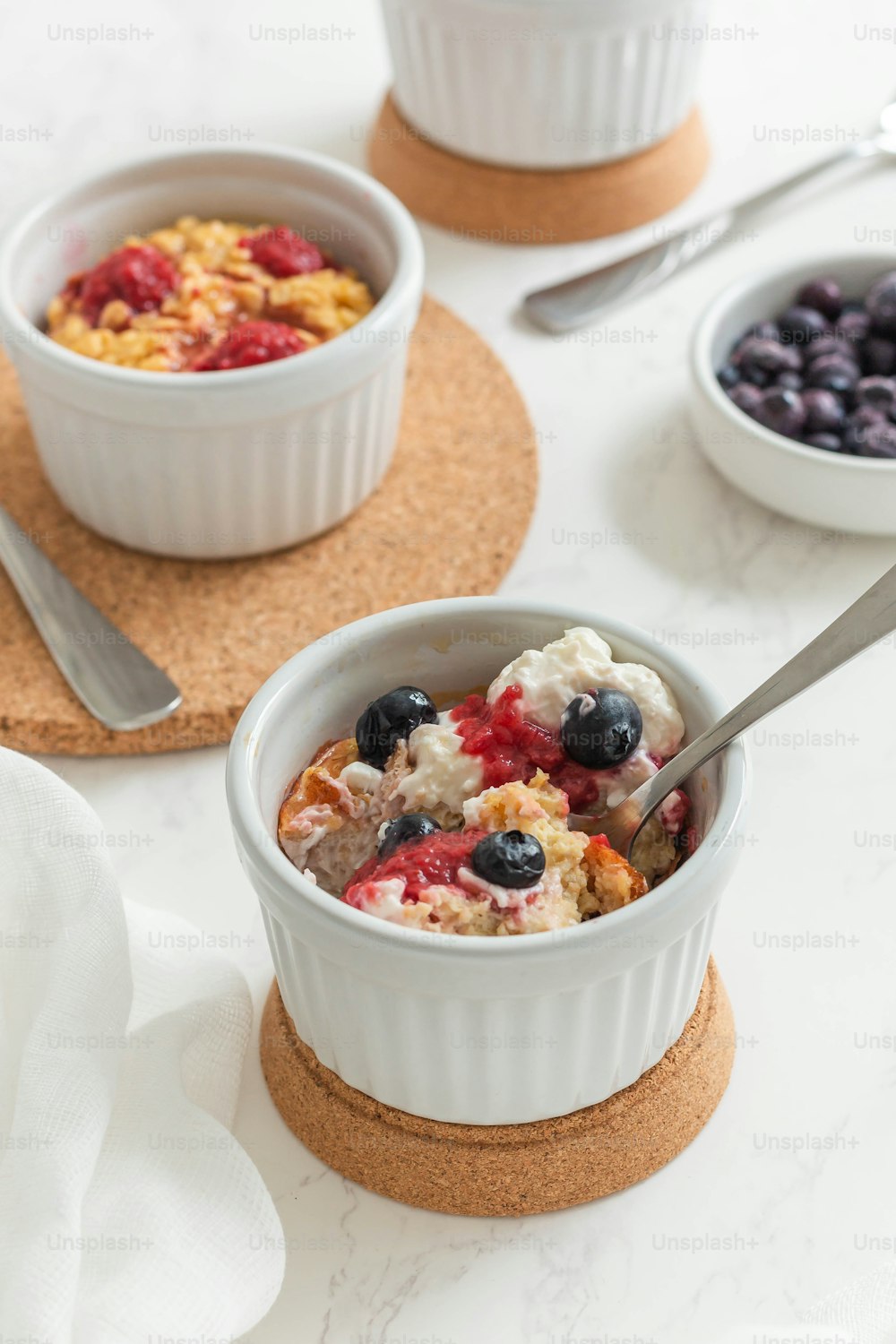 a bowl of oatmeal with berries and blueberries