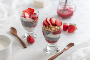 a couple of glasses filled with food on top of a table