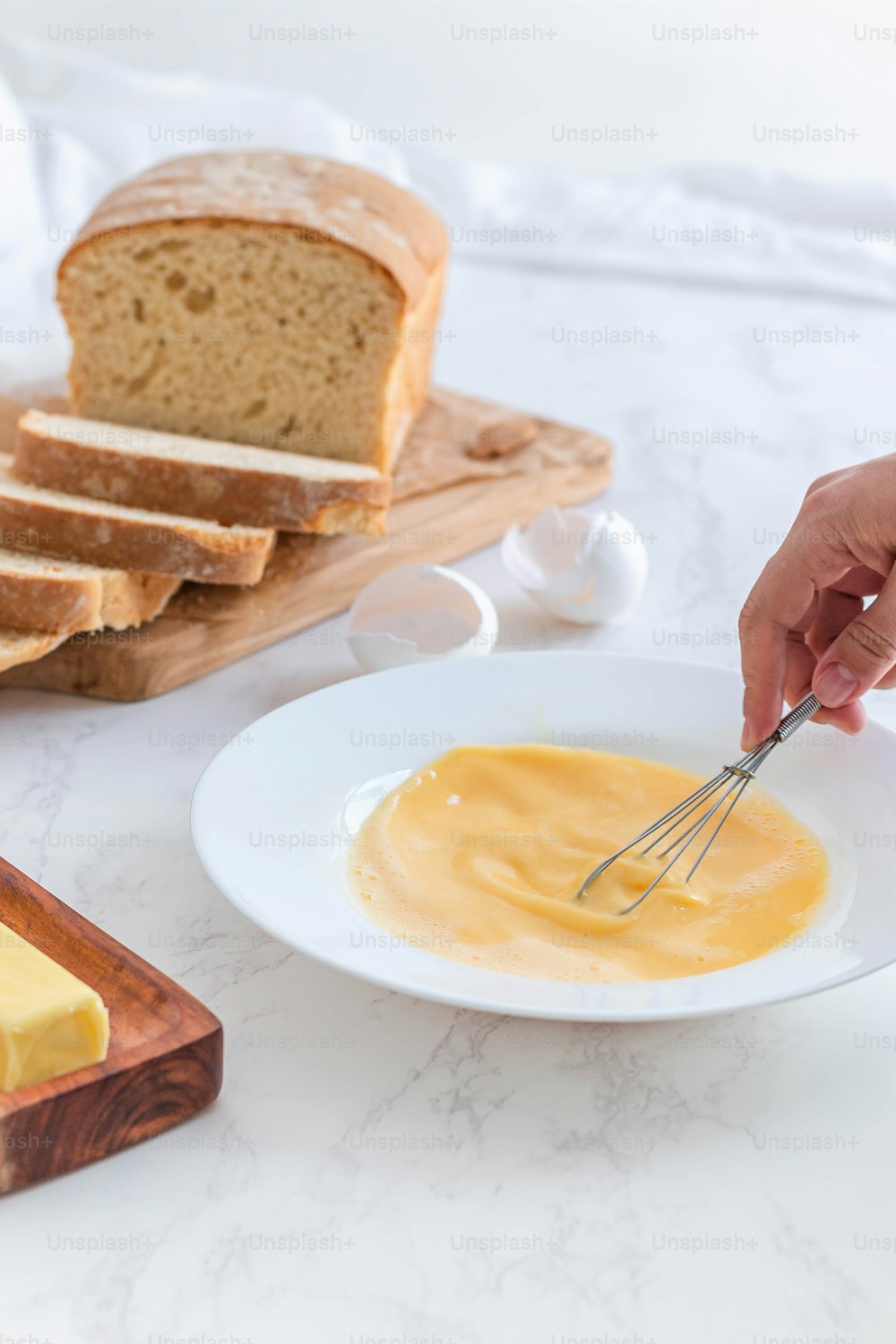 a person is spreading butter on a plate