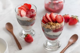 a couple of glasses filled with food on top of a table