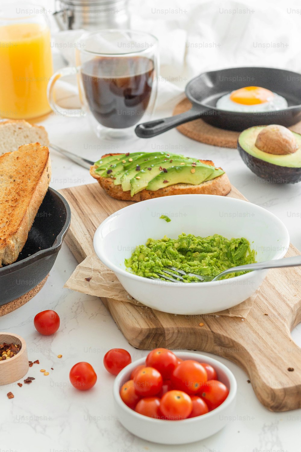 a table topped with a bowl of guacamole and bread