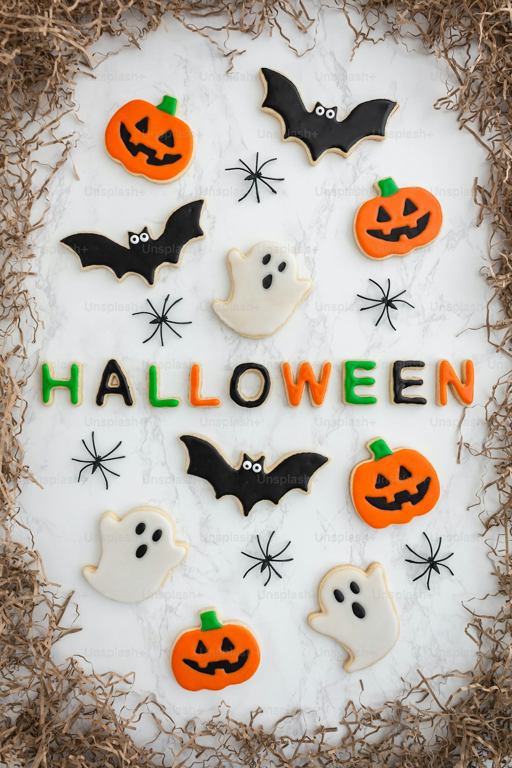 decorated cookies in the shape of bats and pumpkins