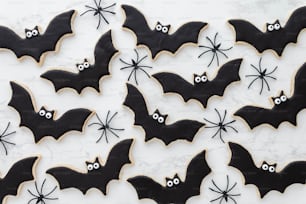 decorated cookies with black icing and decorated bats