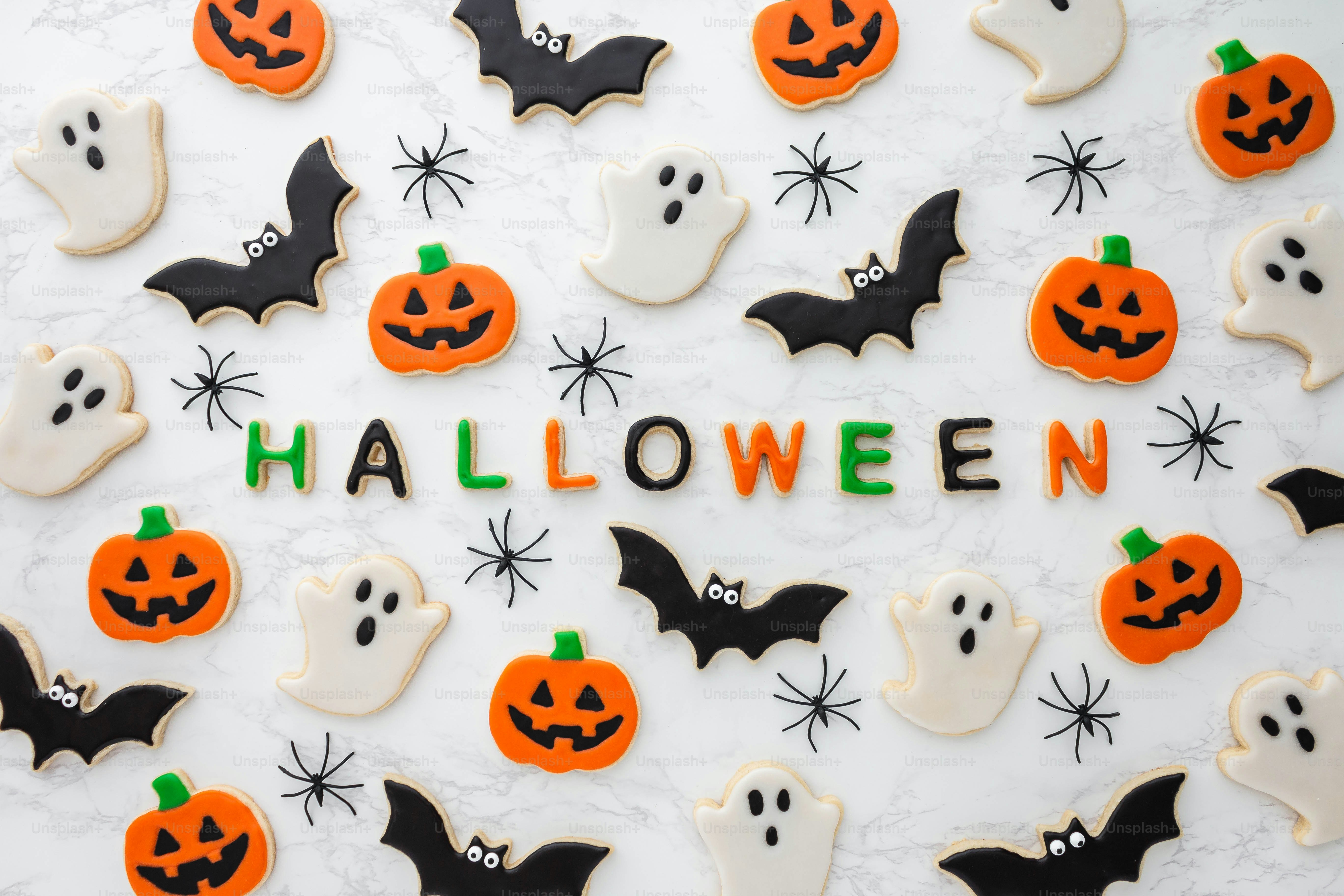 a table topped with lots of decorated cookies