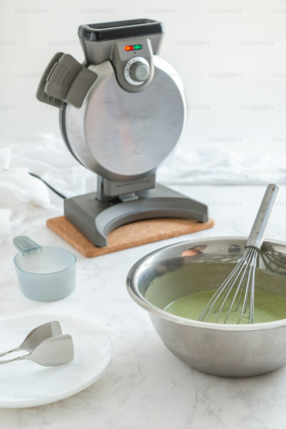 a bowl with a whisk in it next to a mixer