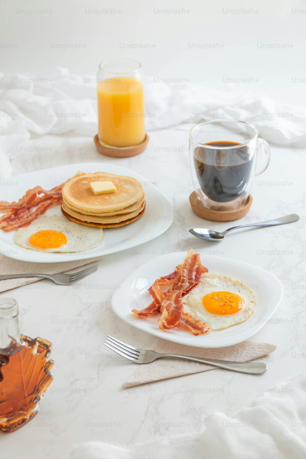 a breakfast of eggs, bacon, pancakes and coffee