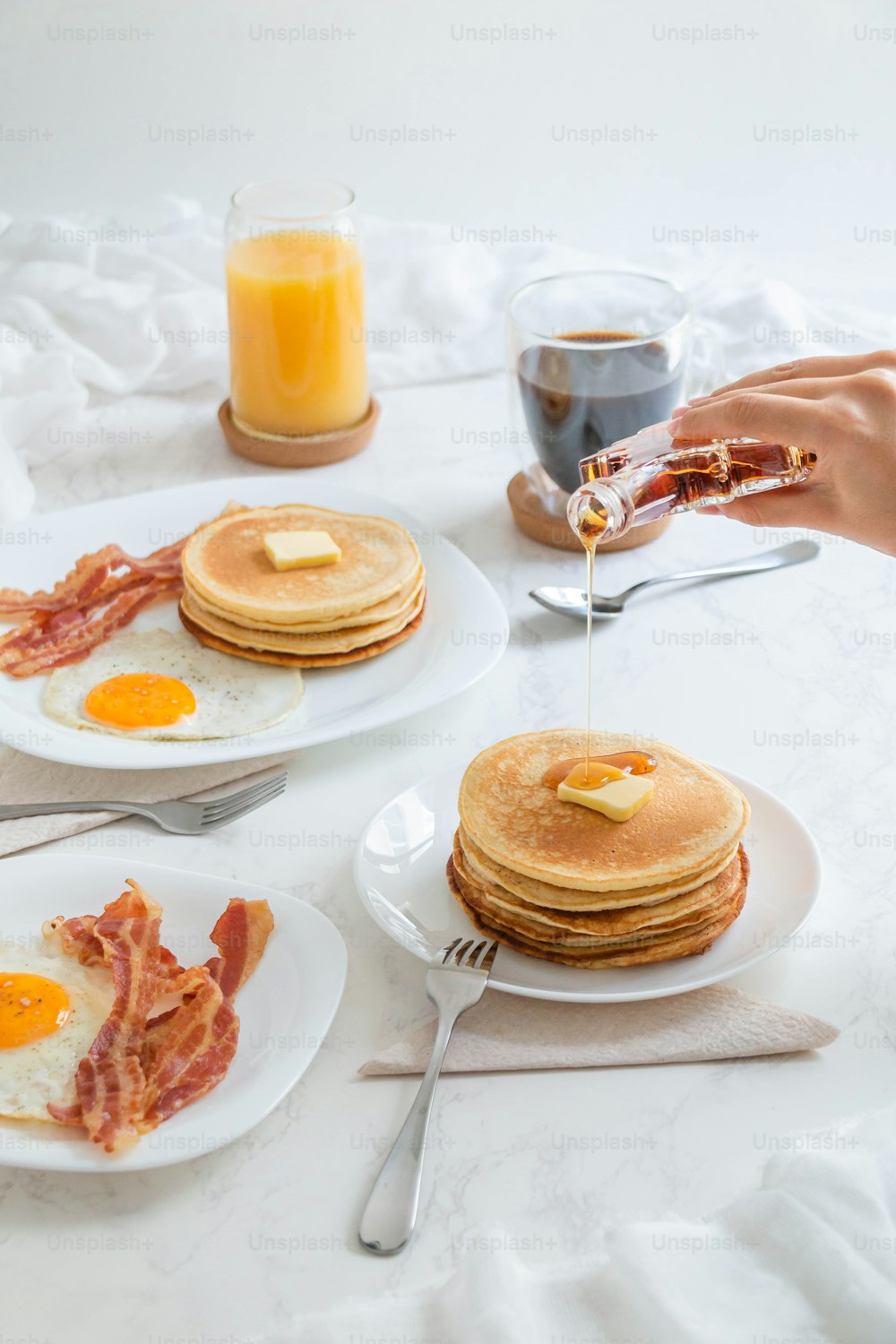 a table topped with plates of breakfast foods