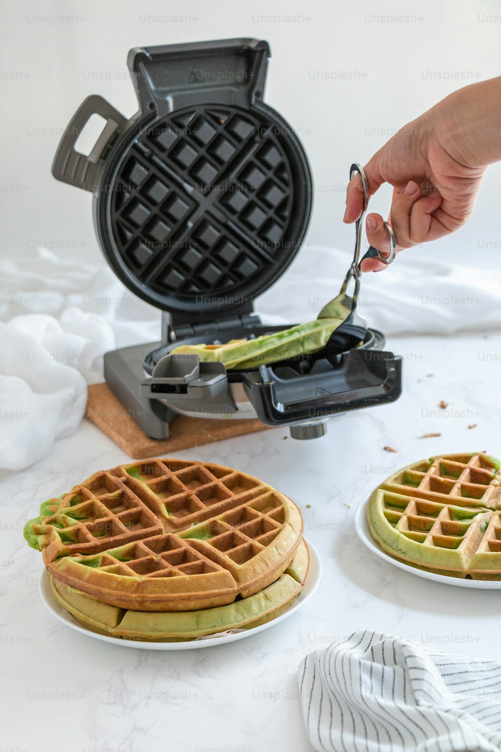 a waffle being cut with a knife and fork