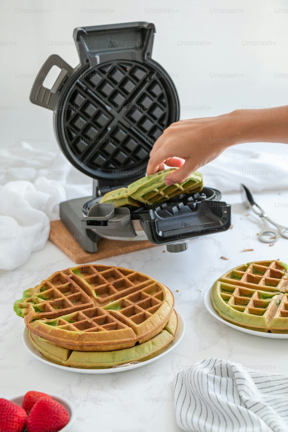 a waffle maker being used to make waffles