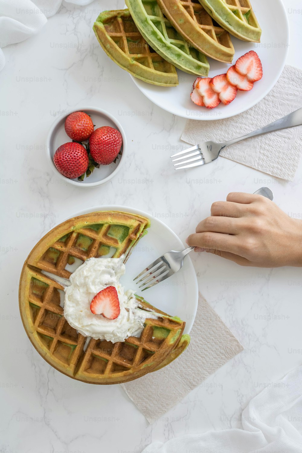 a waffle topped with whipped cream and sliced strawberries