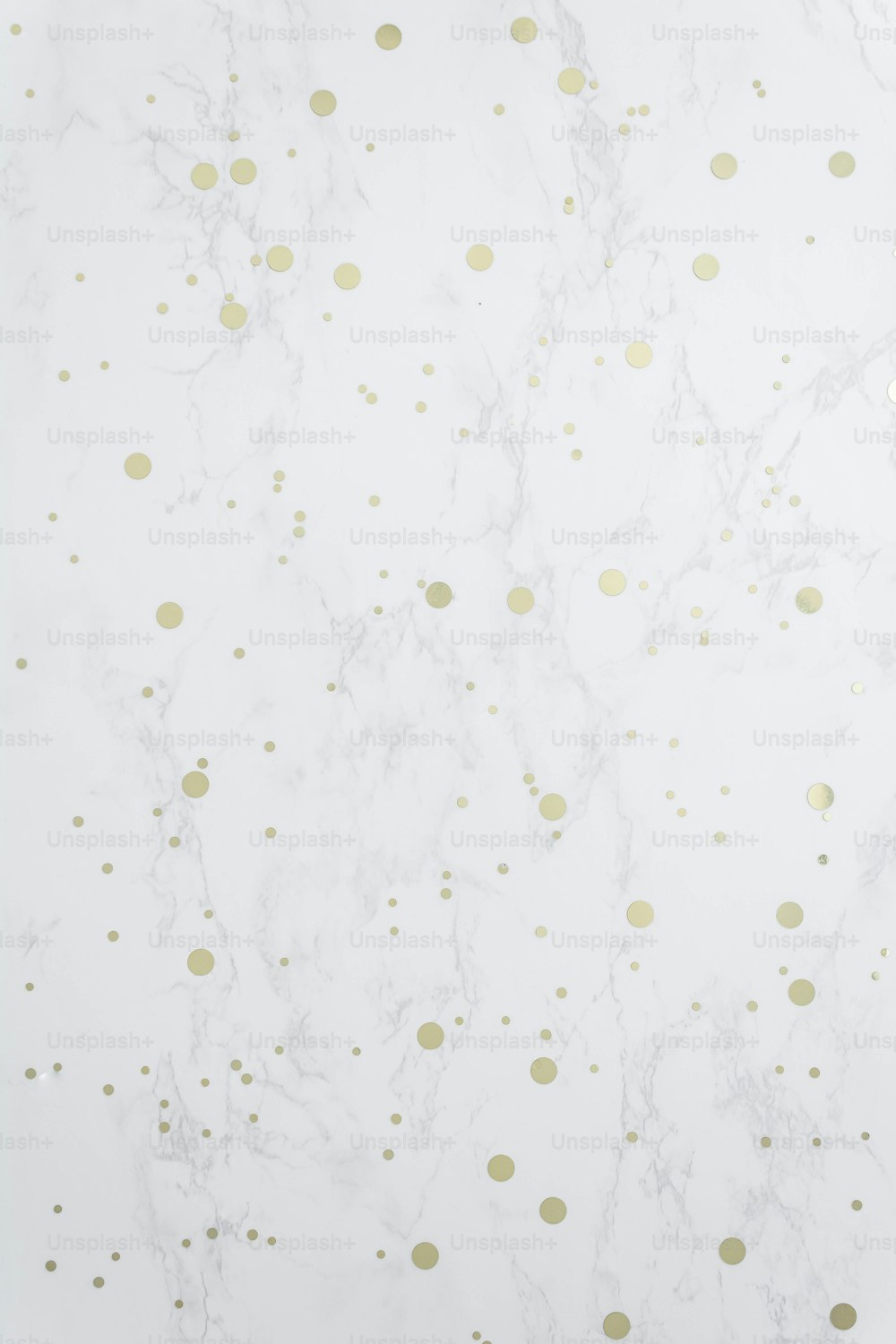 a marble wall with gold dots on it