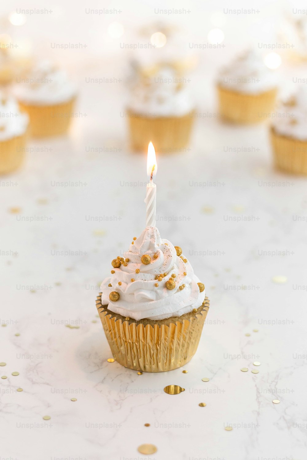 a cupcake with a lit candle on top of it