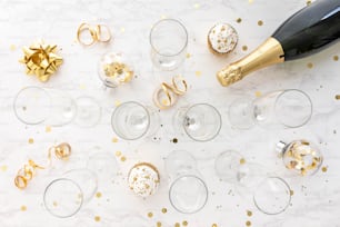 a table topped with glasses and a bottle of champagne