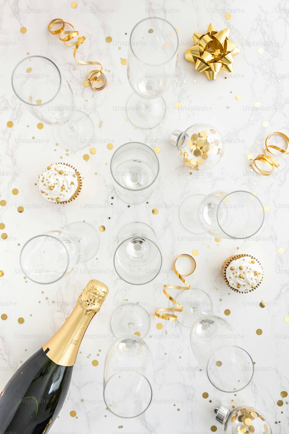 a bottle of champagne sitting next to a bunch of wine glasses