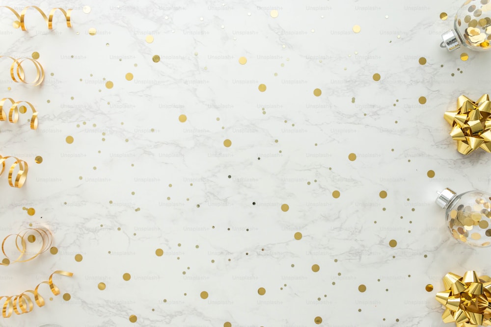 A marble table with gold and silver decorations photo – Gold confetti ...