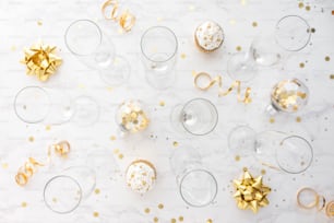 a table topped with lots of glasses filled with cupcakes