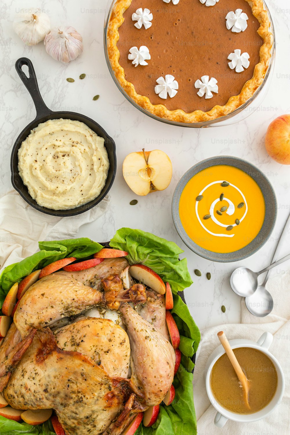 a table topped with a turkey and a pie