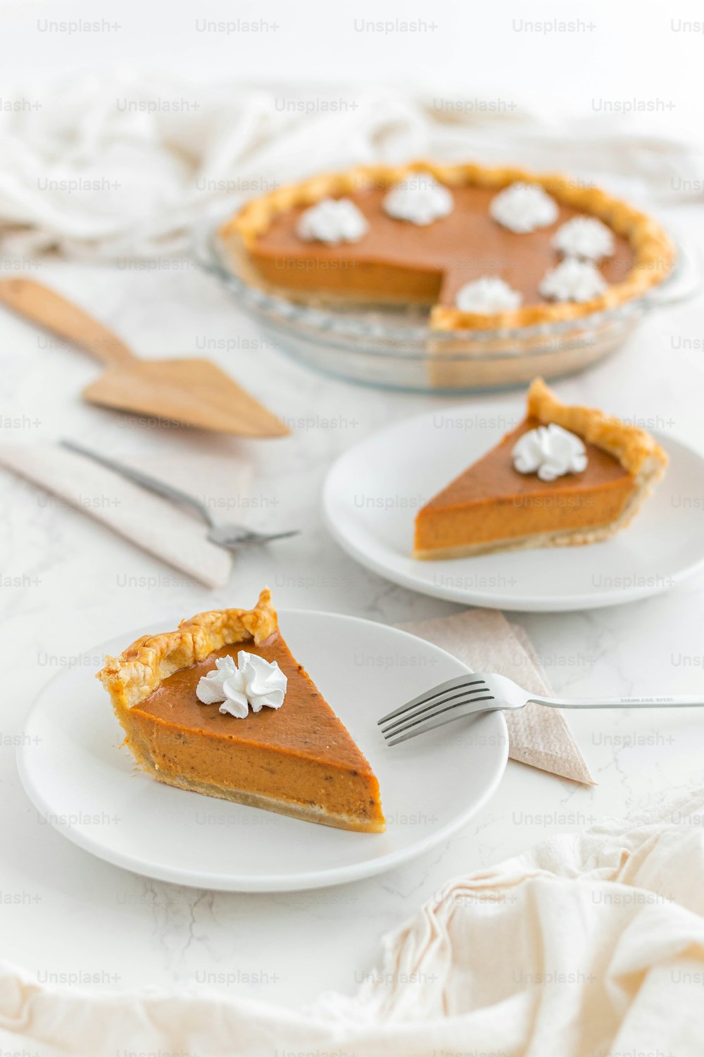 a slice of pumpkin pie on a plate with a fork