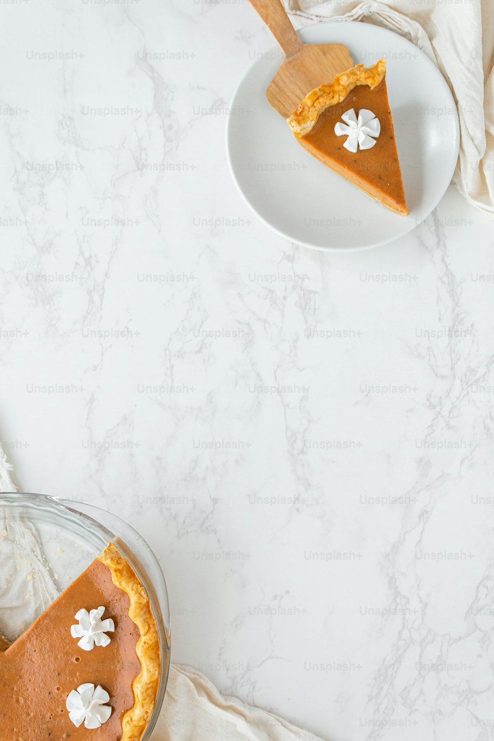 a slice of pumpkin pie on a white plate
