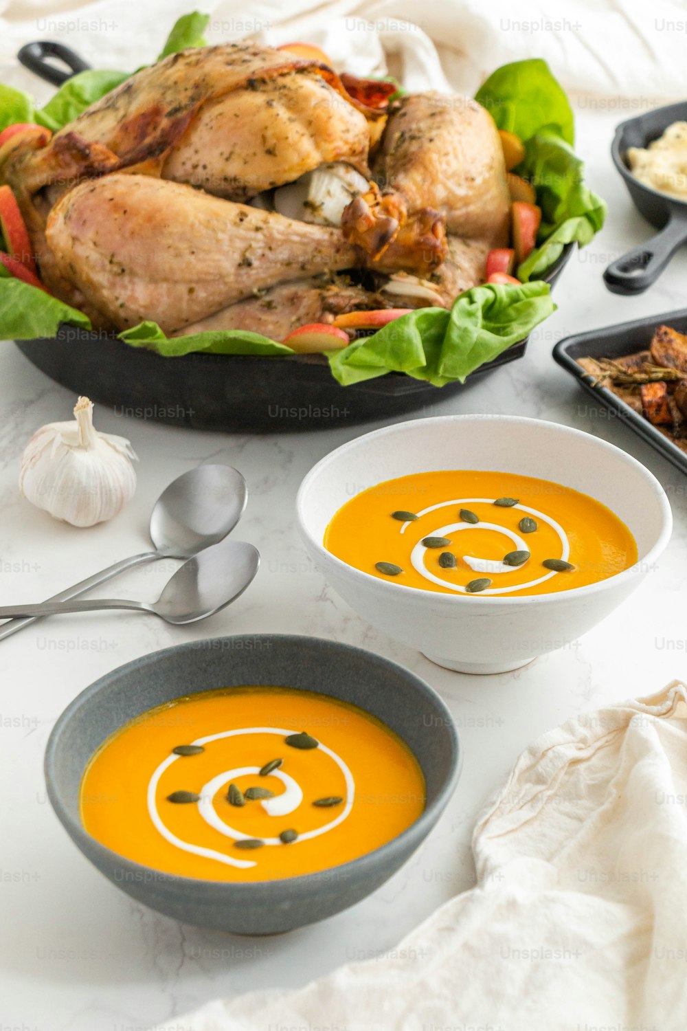 a table topped with bowls of soup and a turkey