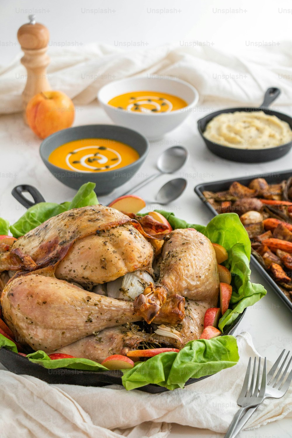 a roasted turkey in a pan with carrots, carrots, and potatoes
