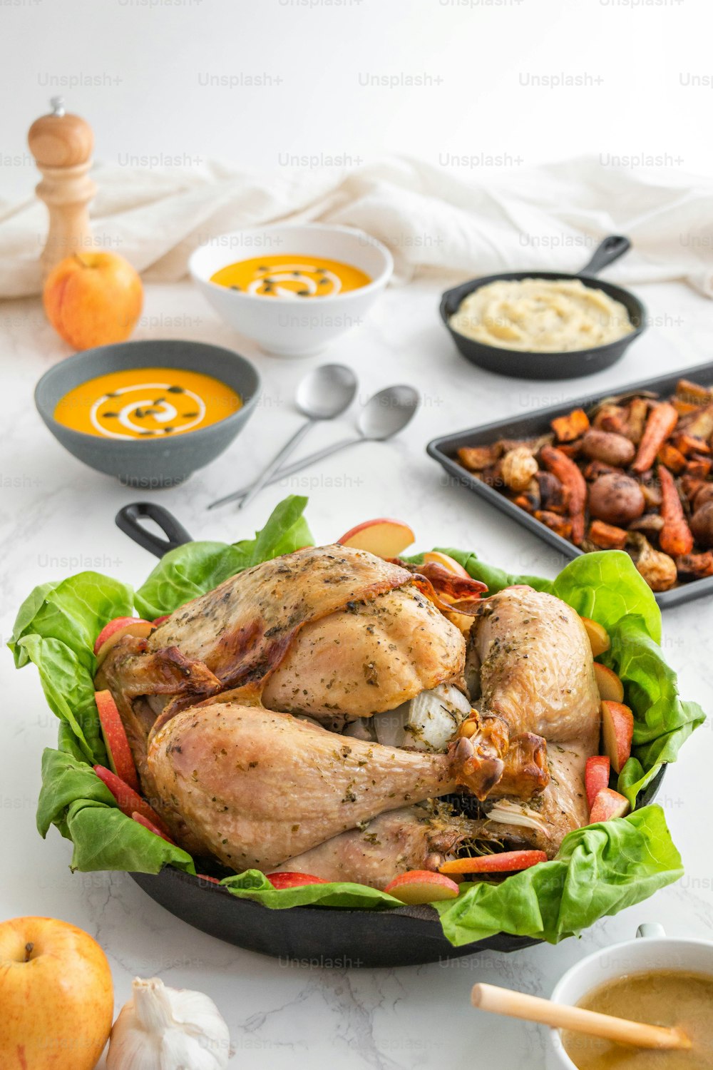 a turkey in a pan with carrots, potatoes, and other ingredients