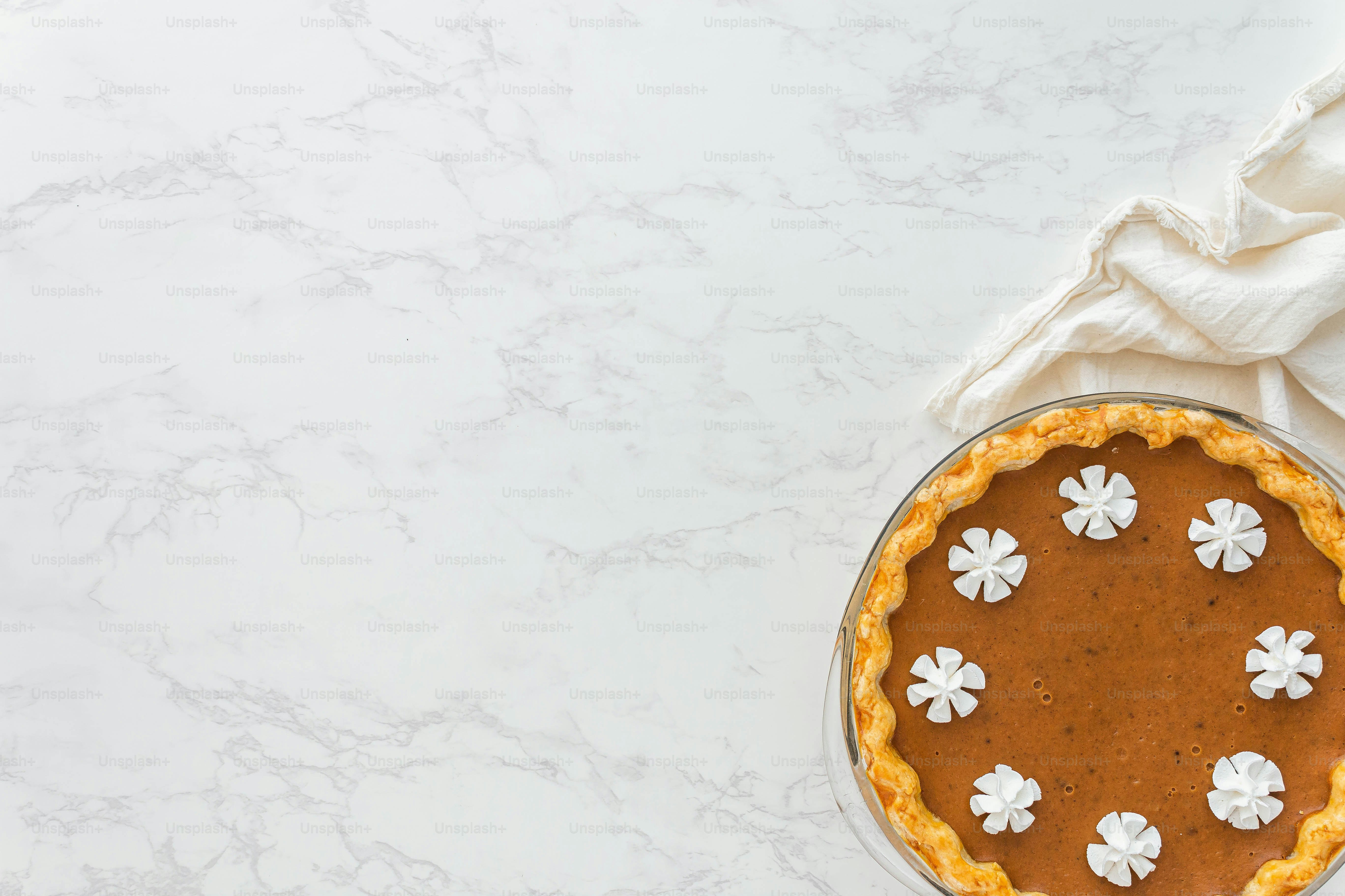 A pie sitting on top of a white table photo Pie Image on Unsplash