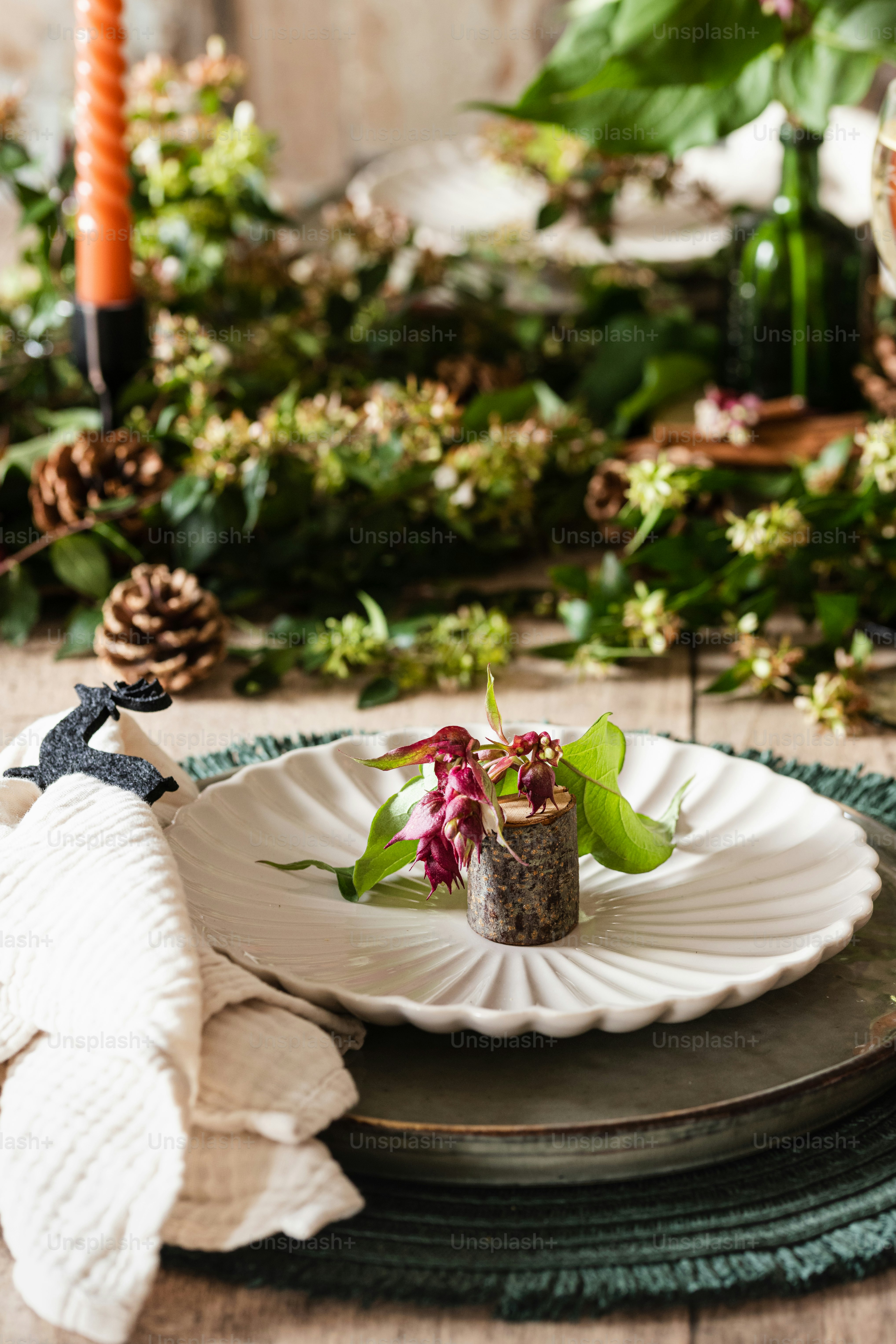 a white plate topped with a small flower on top of a wooden table