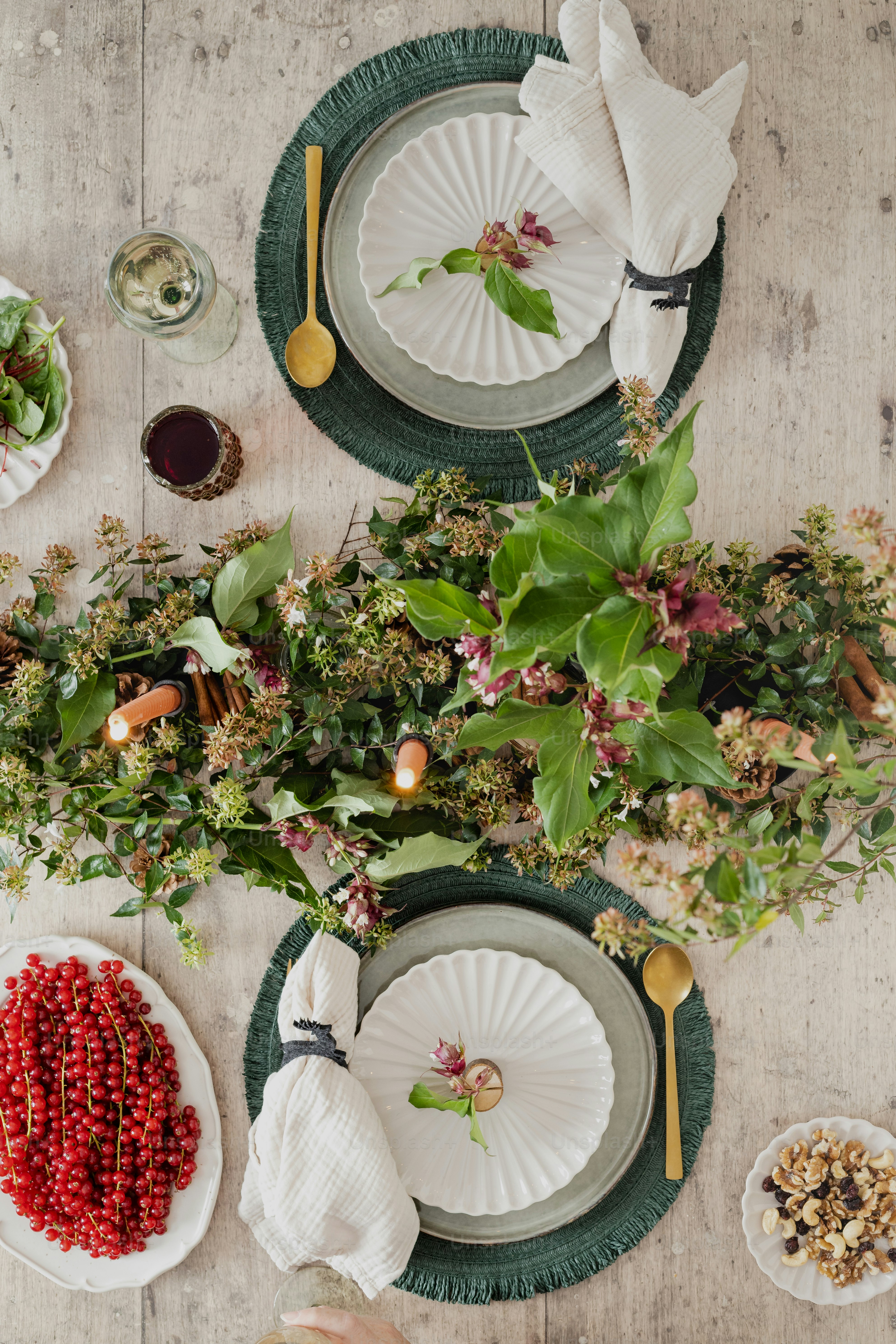 a table topped with plates of food and flowers