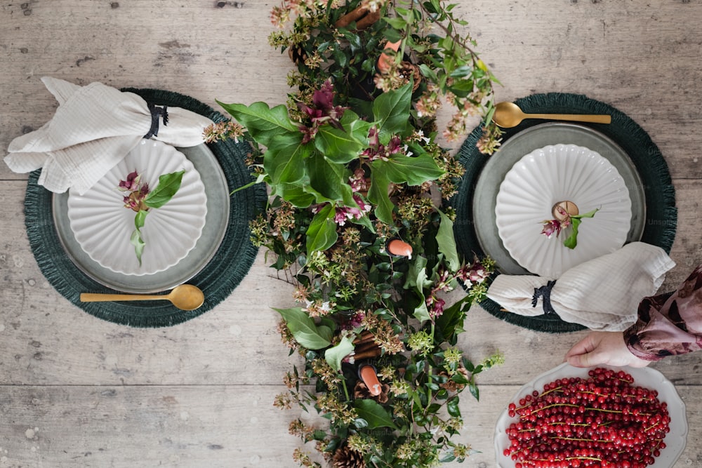 a table topped with plates of food and flowers