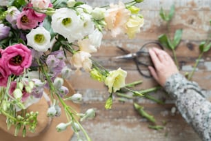 a person cutting flowers with a pair of scissors