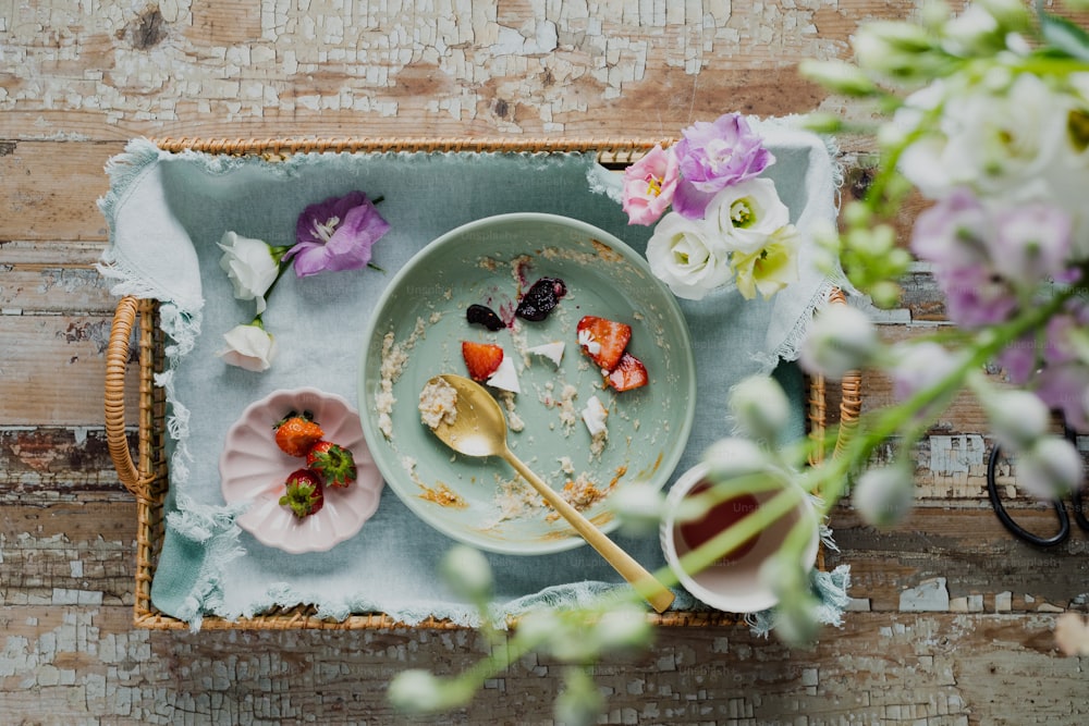 a plate of food on a tray with flowers