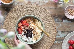 a bowl of fruit and nuts on a table