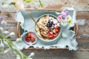 a bowl of fruit and yogurt with a spoon