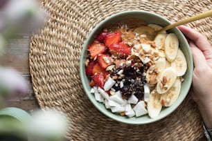 a bowl of fruit and nuts with a spoon in it