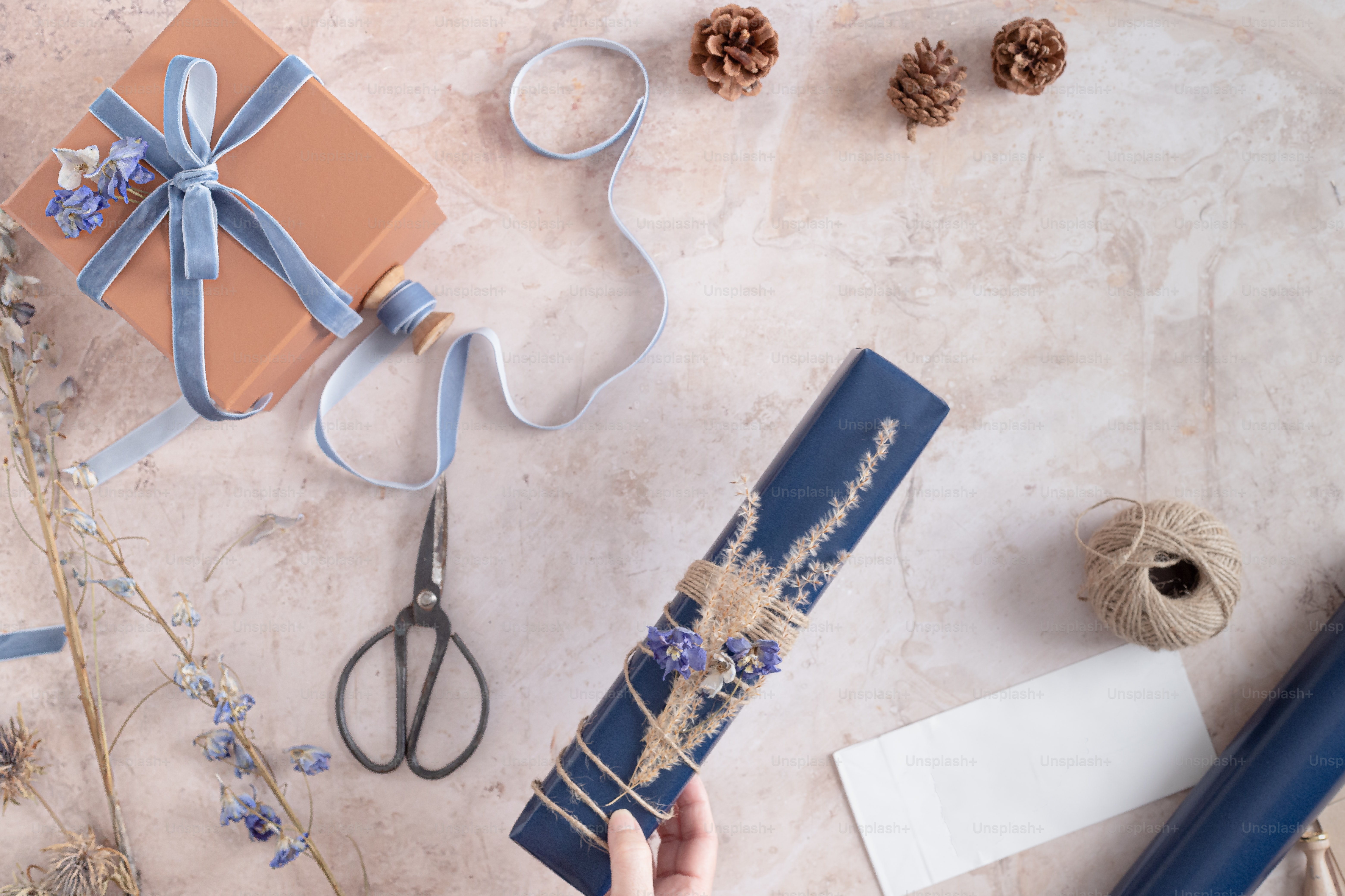 a person is holding a blue wrapping paper