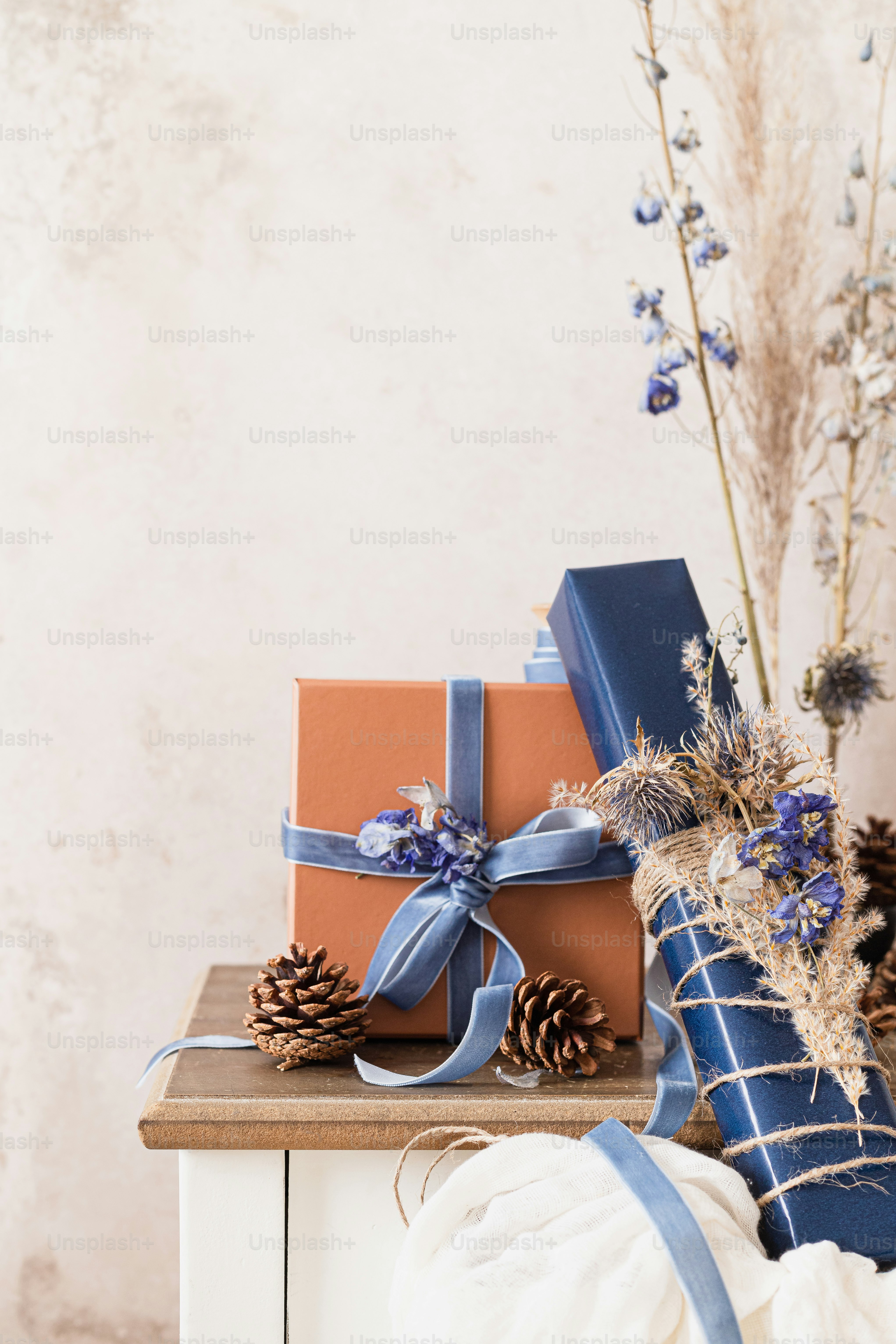 a stack of wrapped presents sitting on top of a table