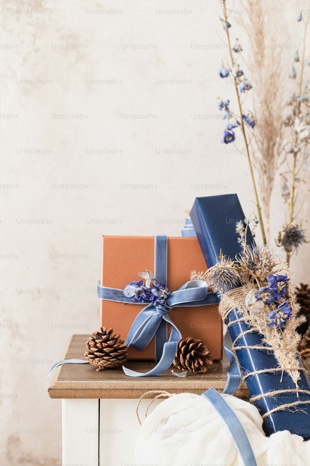 a stack of wrapped presents sitting on top of a table