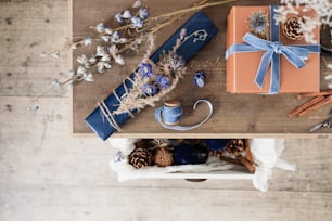 a wooden table topped with gifts and flowers