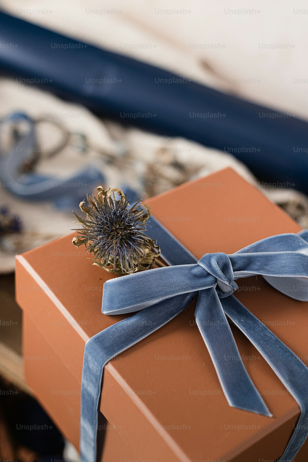 a brown box with a blue ribbon tied around it