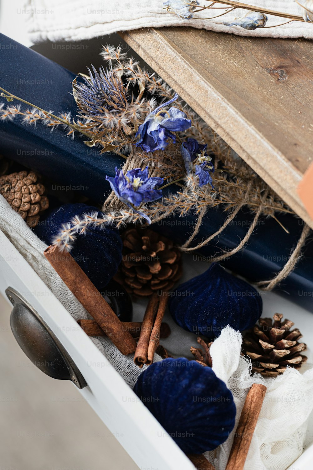 a close up of a drawer filled with pine cones