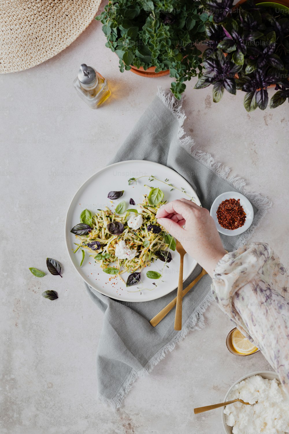 a person reaching for a plate of food on a table