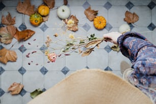 a person holding a bunch of dried flowers