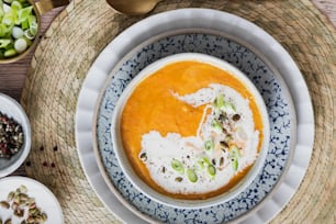 a bowl of carrot soup with a spoon in it