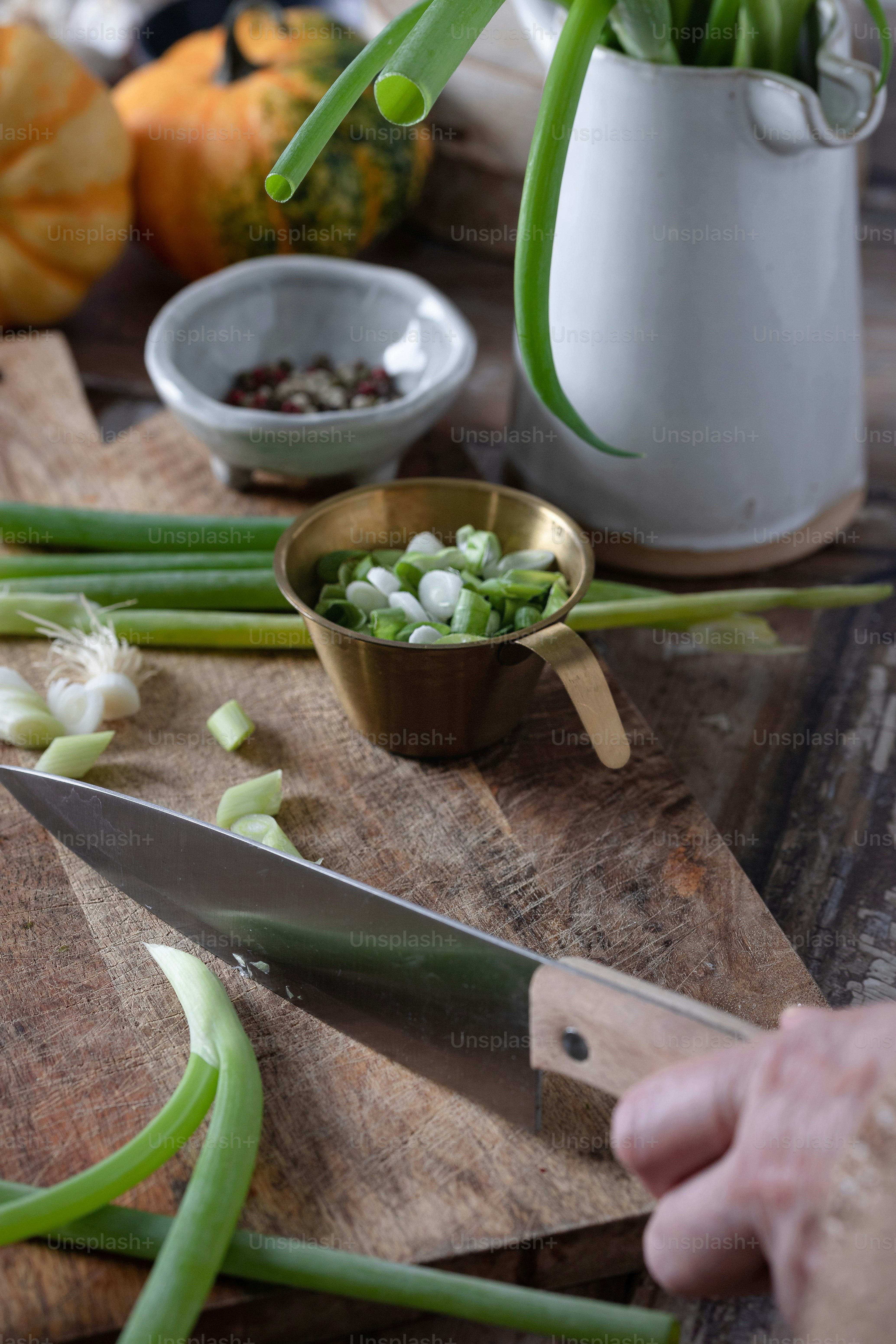 a person chopping onions on a cutting board with a knife