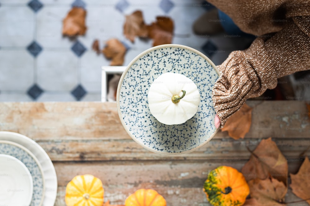 a person holding a plate with a pumpkin on it