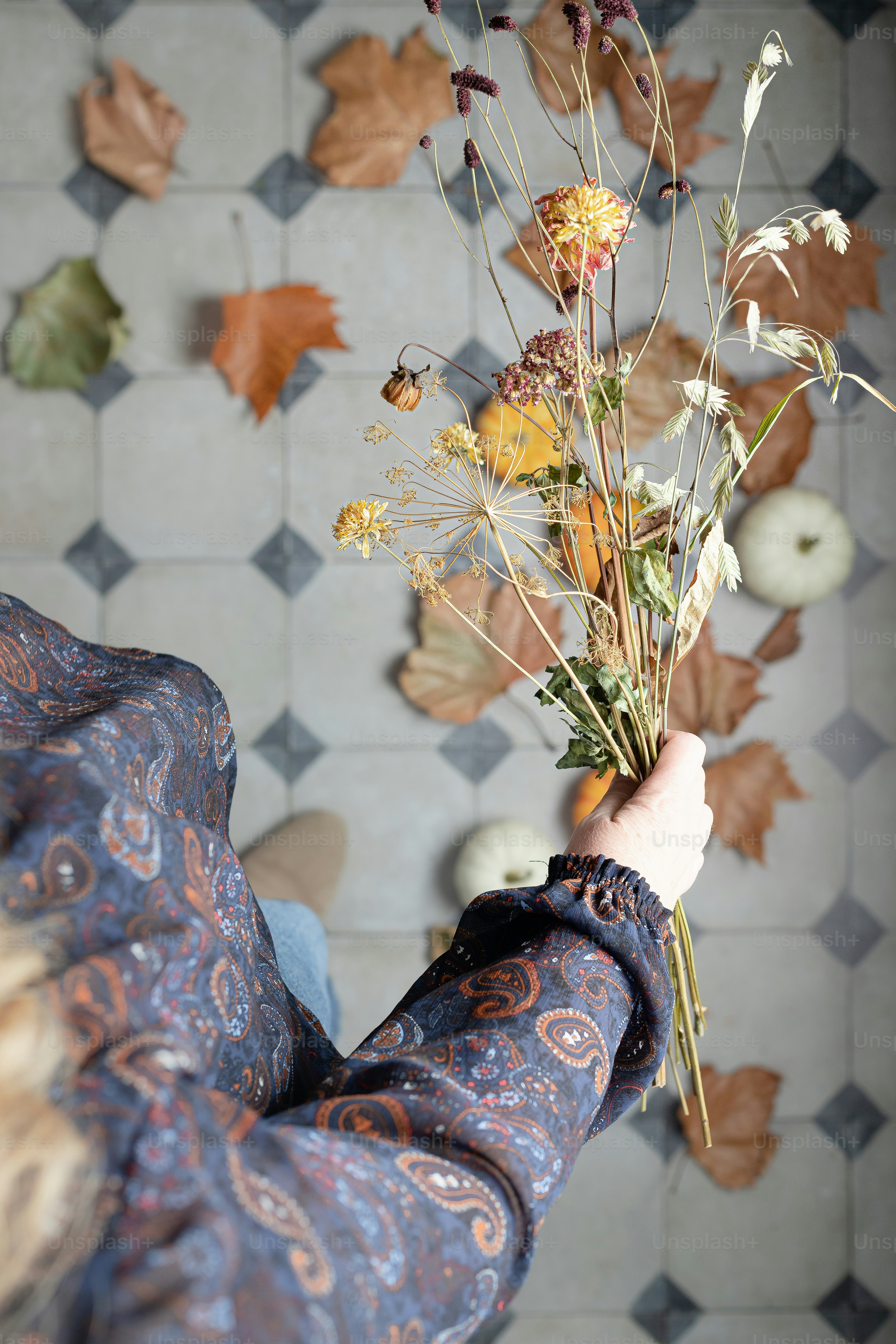 a person holding a bouquet of flowers in their hand