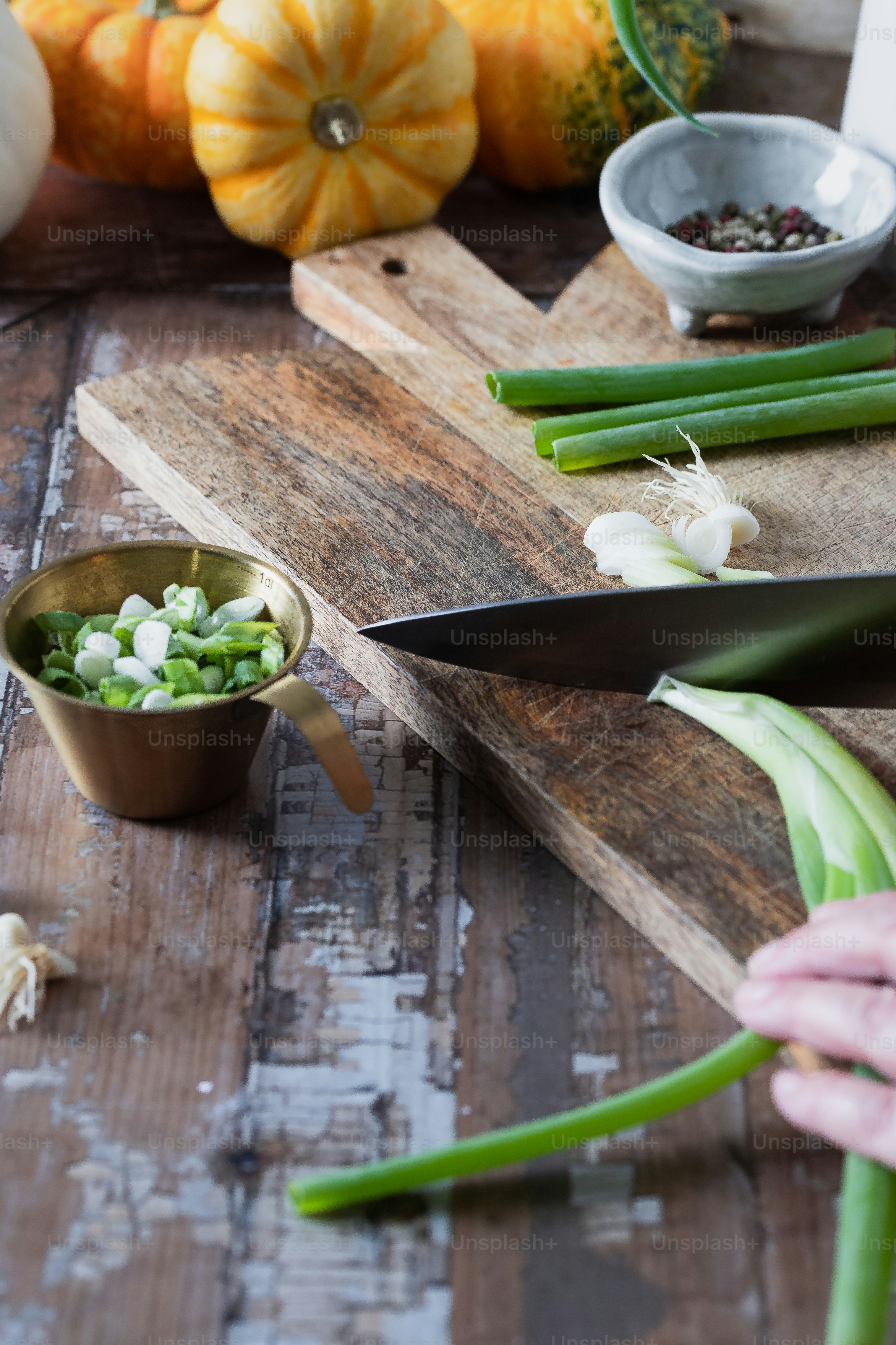 a person cutting up vegetables on a cutting board