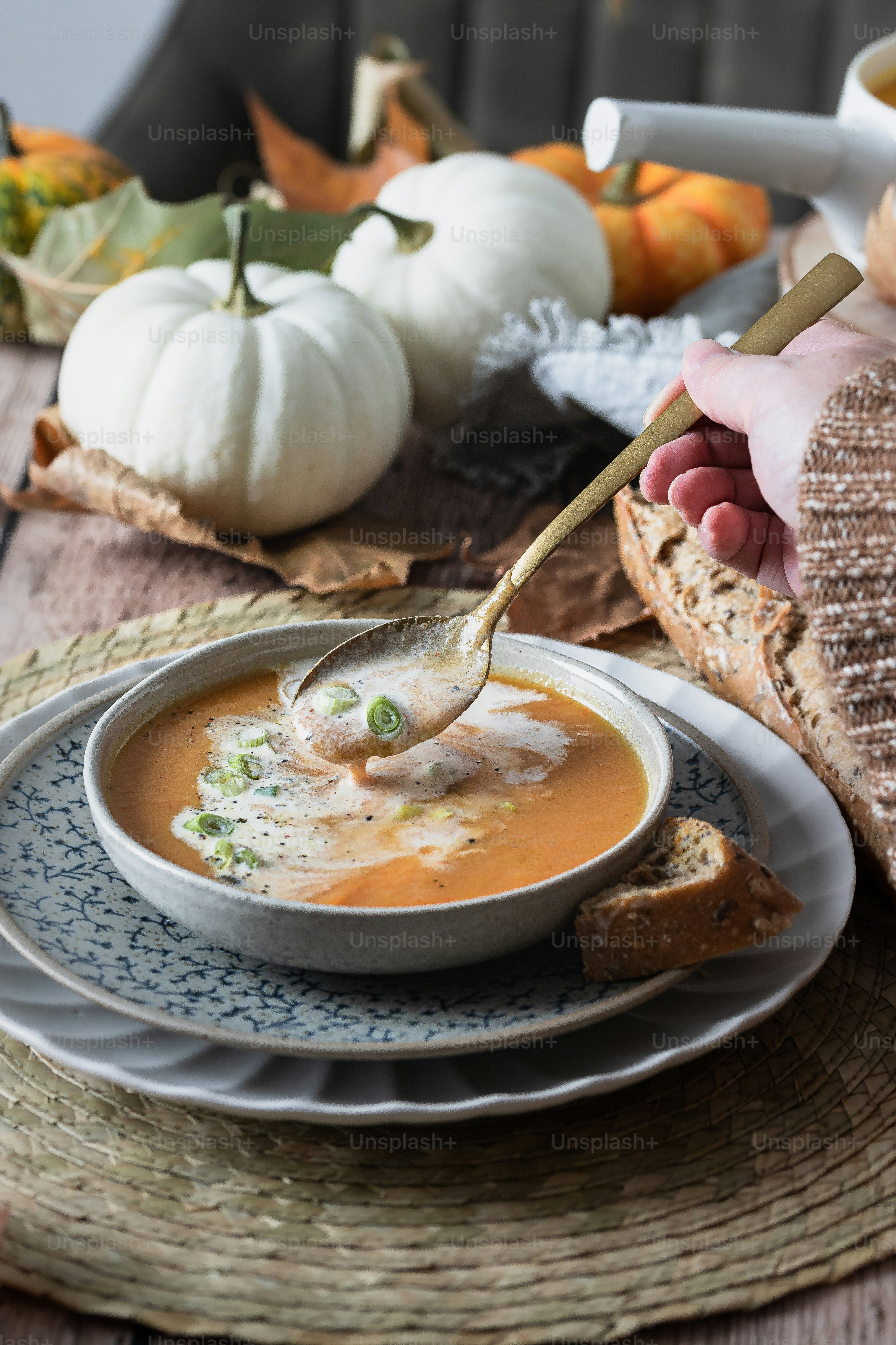a bowl of soup being spooned into a bowl