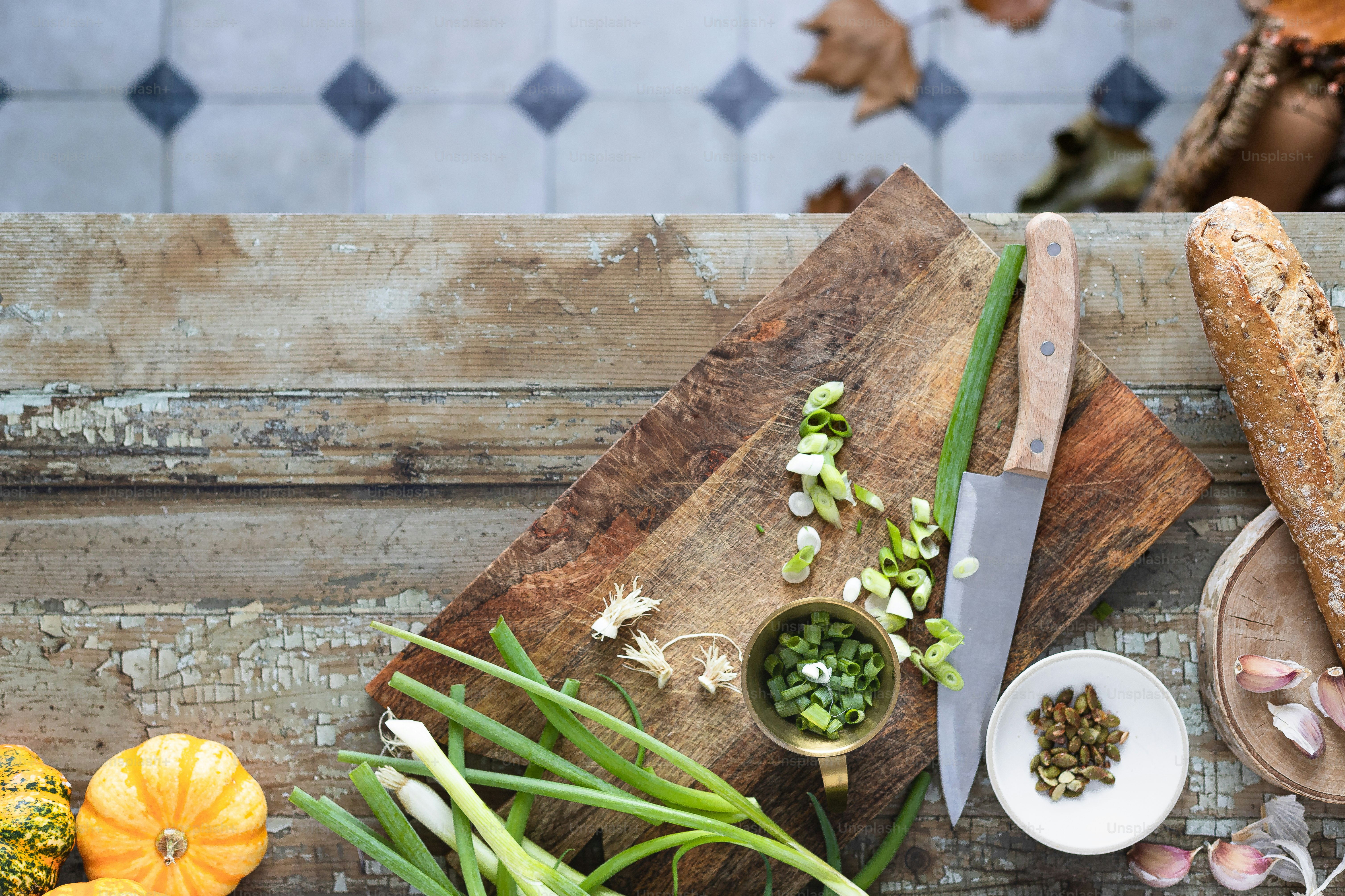 a wooden cutting board topped with vegetables next to a knife
